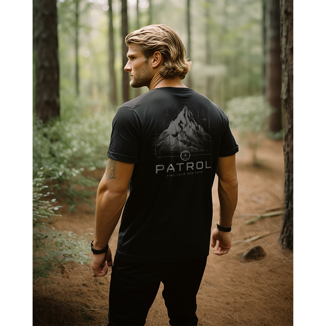 A man in the forest wearing the Patrol Mountain Blueprint Tee, 100% cotton unisex tee, Outdoors