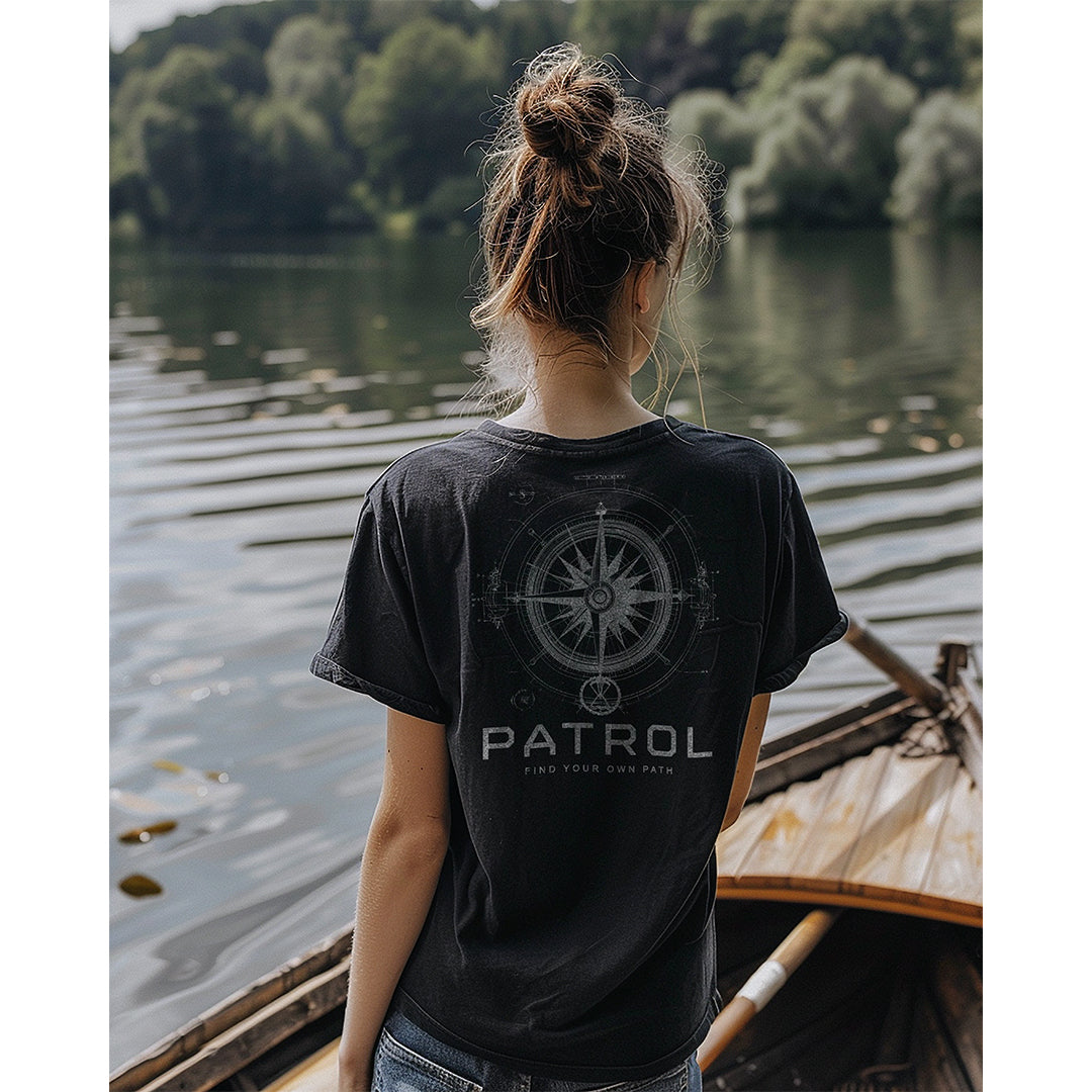a woman wearing the Patrol Nautical Compass Blueprint Tee, rowing boat, outdoors, 100% cotton unisex tee